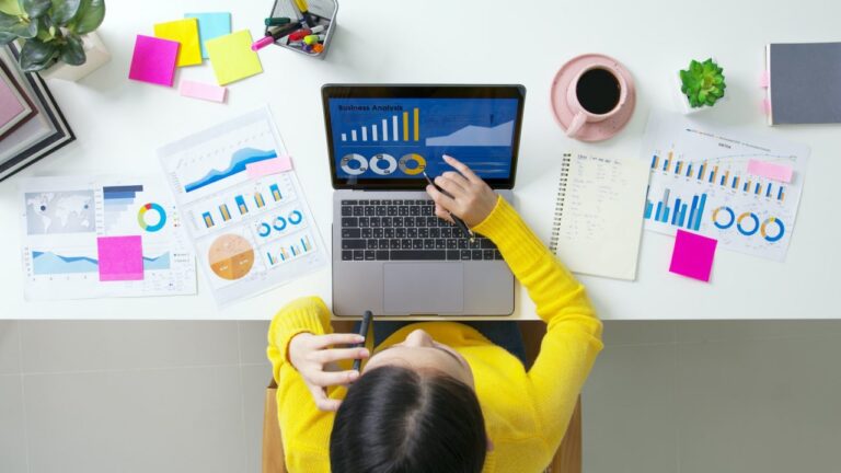 above-top-desk-of-sme-owner-people-home-office-call-talk-in-seo-chart-sale-report